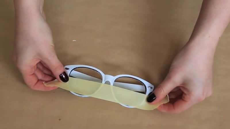 Die Hälfte der Sonnenbrillengläser mit Klebeband bekleben - DIY Designerbrille